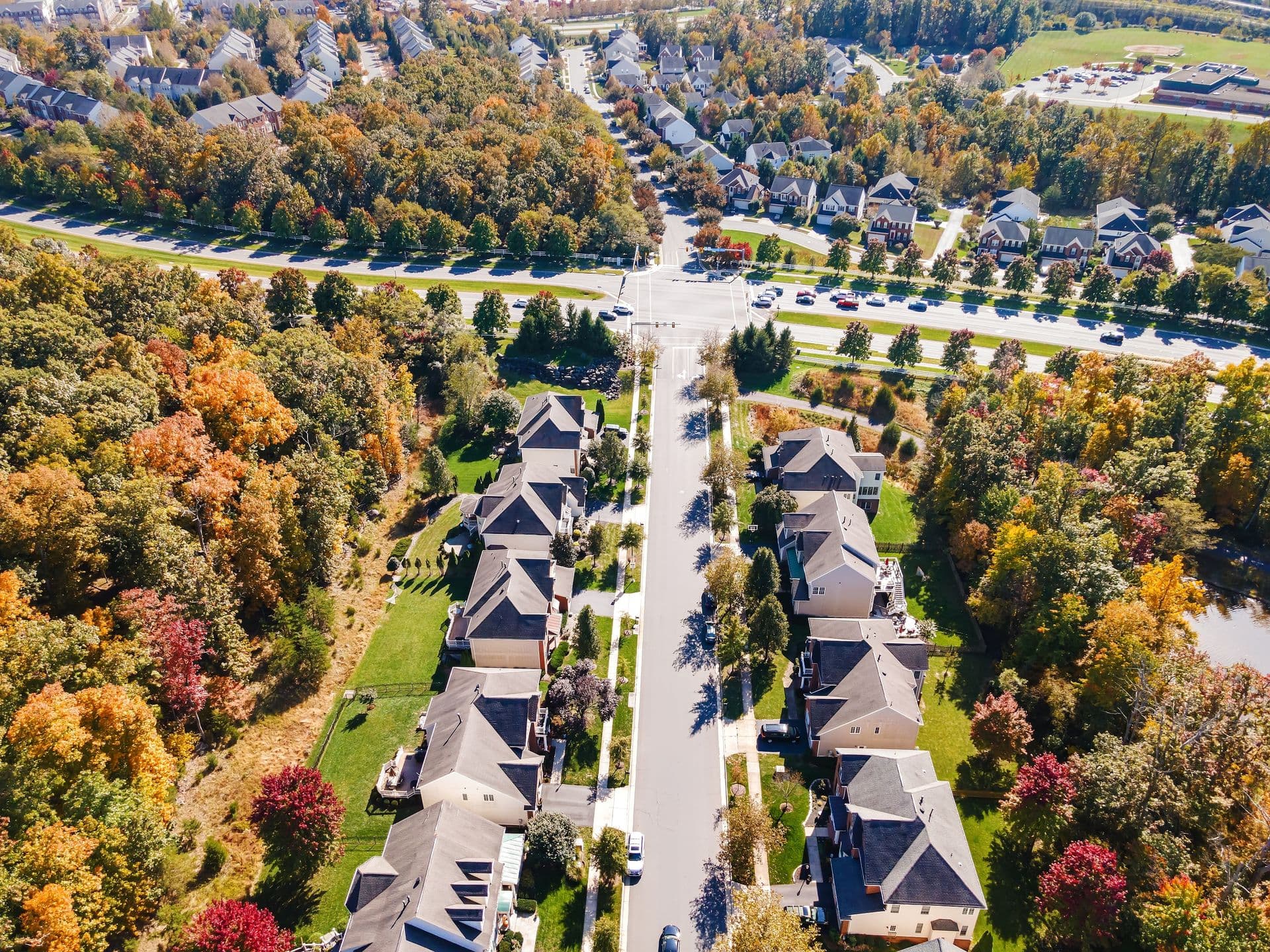 Aerial view of a quiet residential Virginia neighborhood with tree-lined streets and single-family homes, showcasing a well-established community served by reliable plumbing, water treatment, and home services.