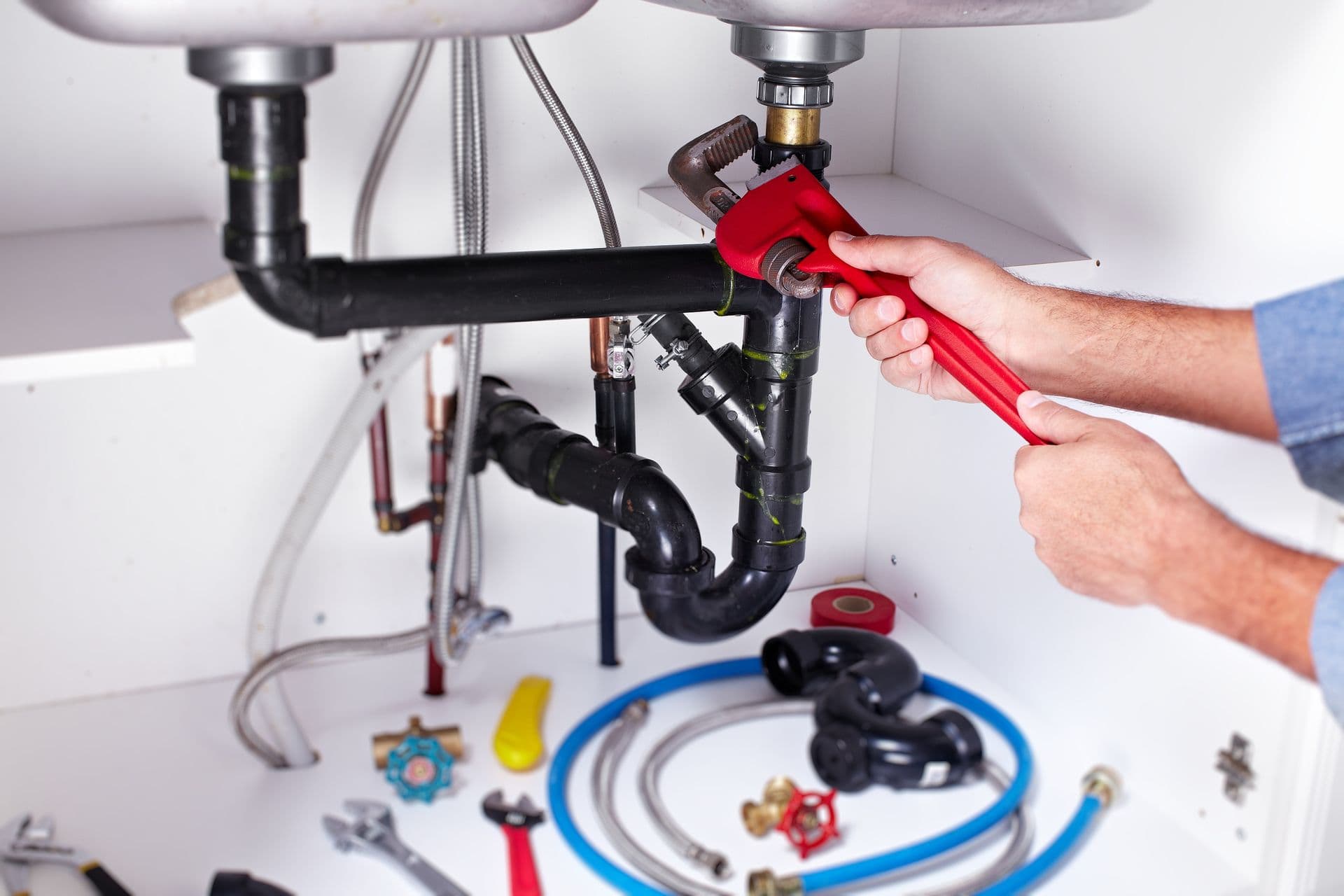 Plumber hands with a wrench. Plumbing renovation background.