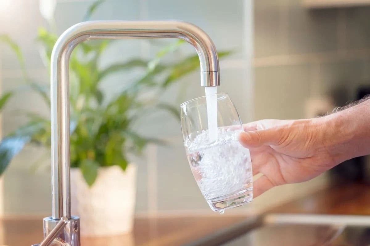 filling up glass with faucet water