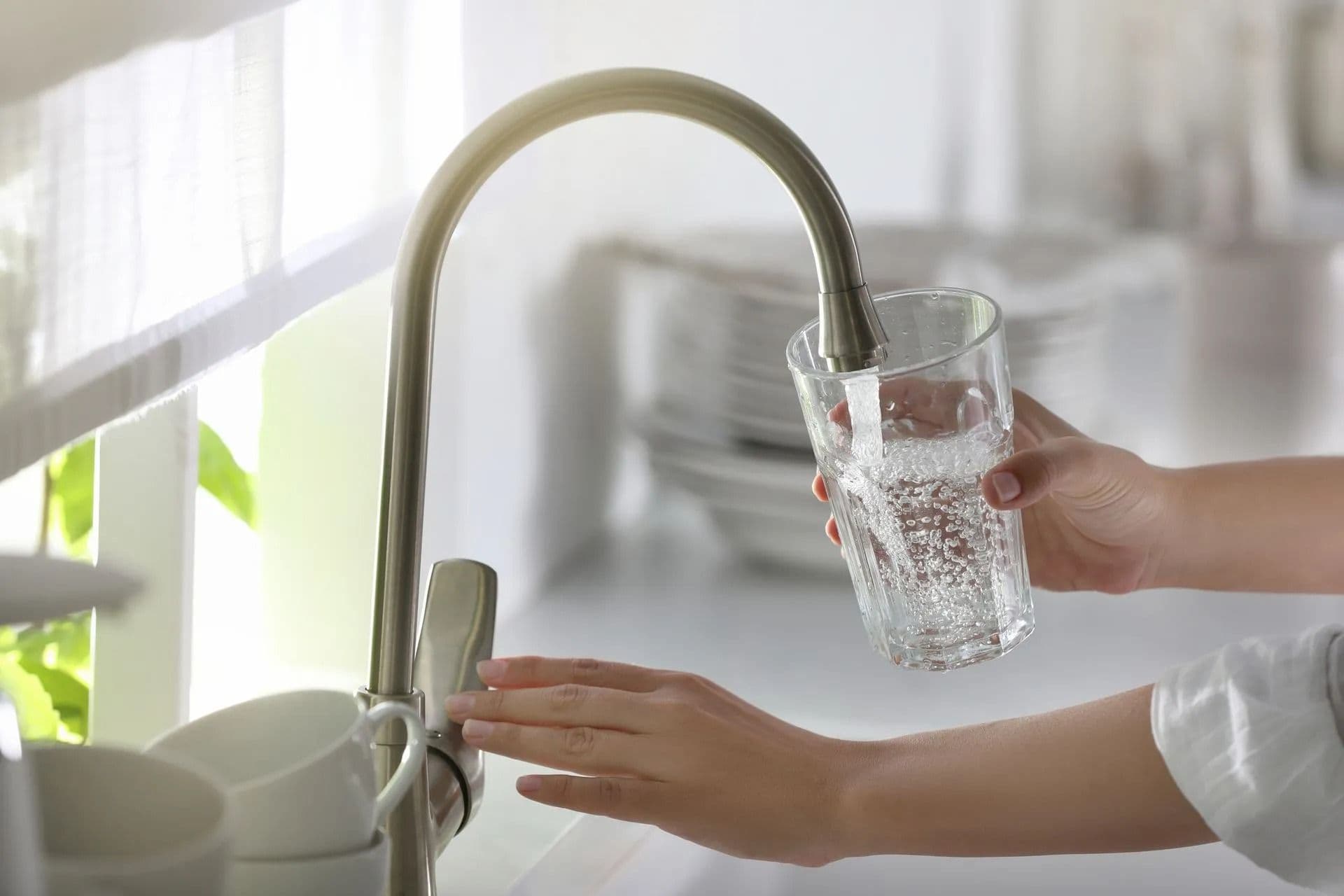 filling up glass with faucet water