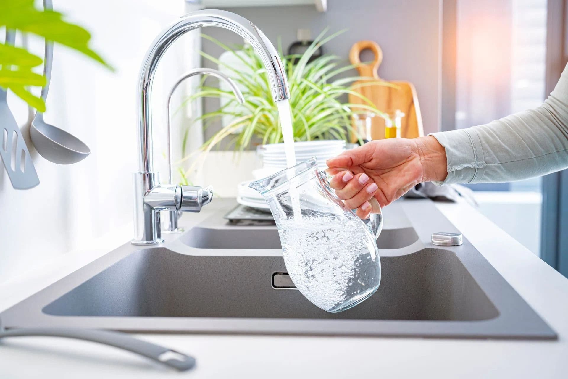 filling up pitcher with faucet water