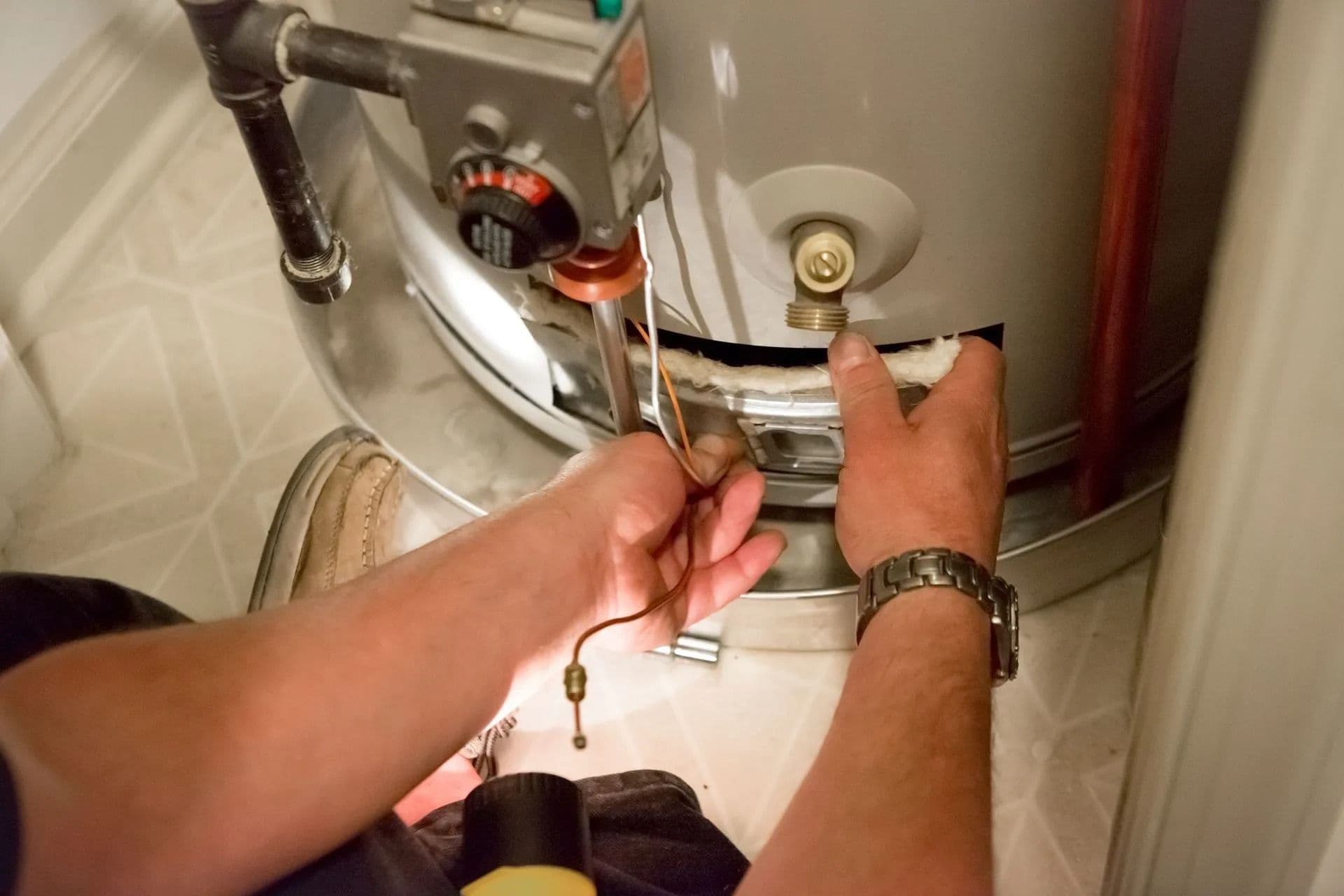 mechanic fixing water heater